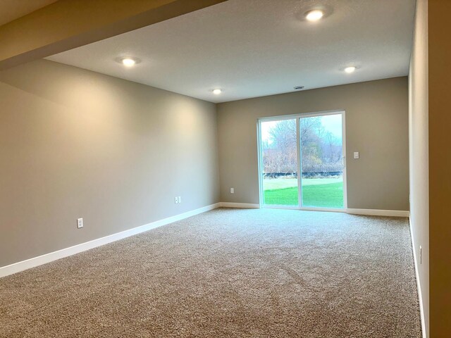 unfurnished room featuring carpet