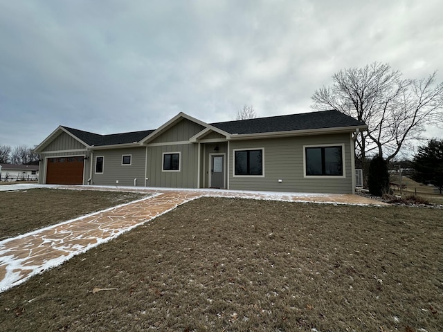 ranch-style house with a garage and a front yard