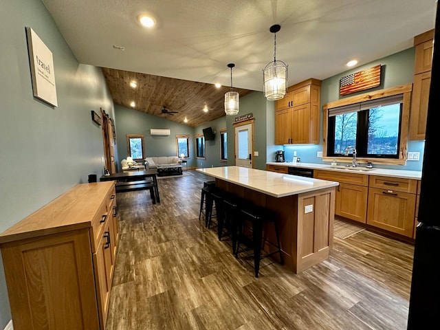 kitchen with lofted ceiling, a center island, sink, and a kitchen bar