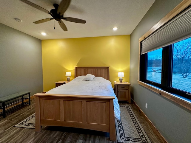 bedroom featuring ceiling fan and dark hardwood / wood-style flooring