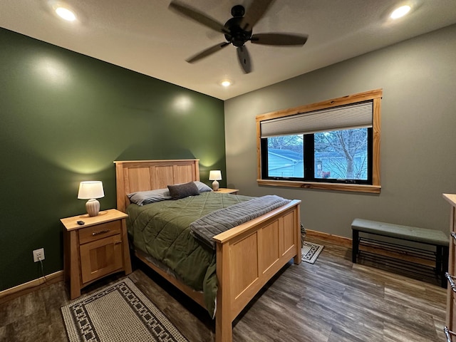 bedroom with dark hardwood / wood-style flooring and ceiling fan