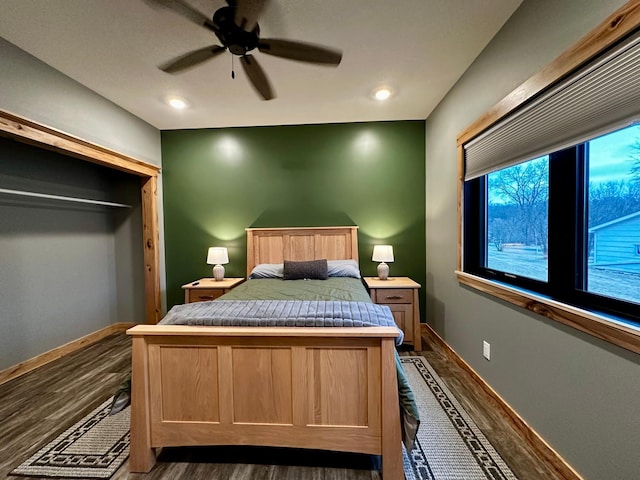 bedroom with dark wood-type flooring, a closet, and ceiling fan