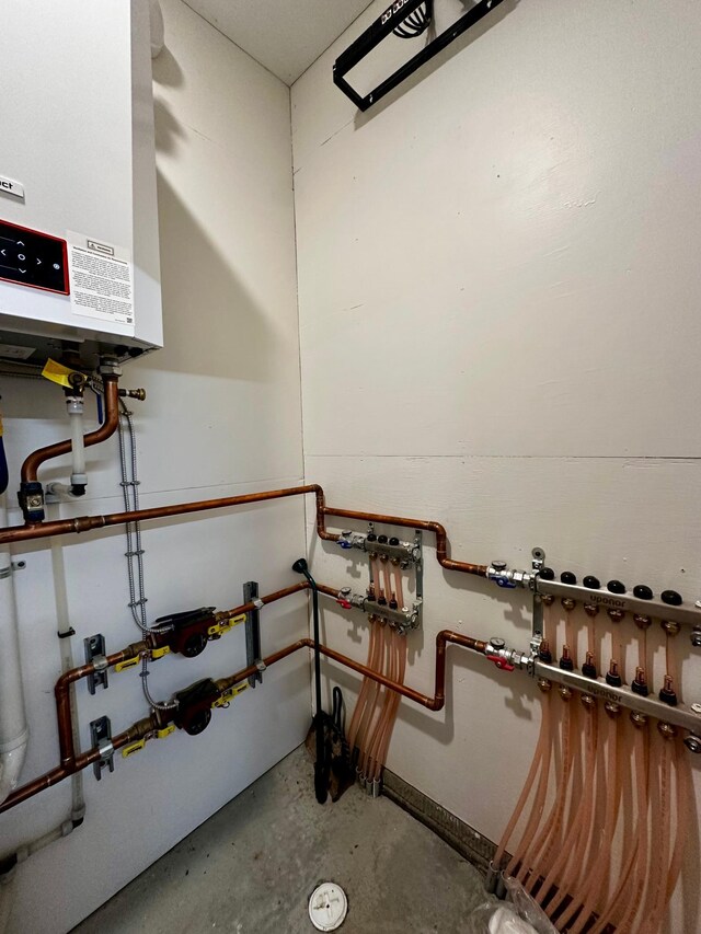 utility room featuring water heater