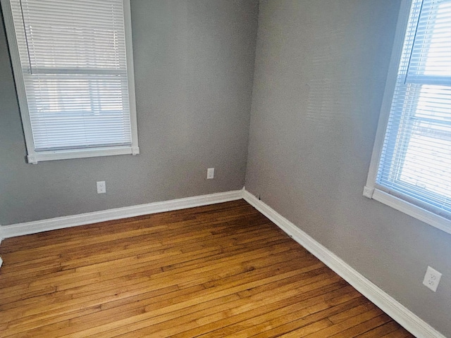 unfurnished room with hardwood / wood-style floors