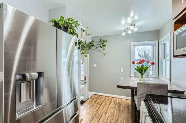 kitchen featuring appliances with stainless steel finishes and light hardwood / wood-style floors