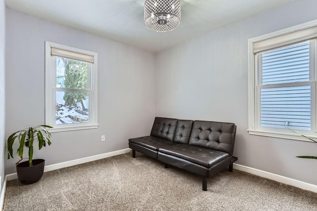 sitting room with a chandelier and carpet floors