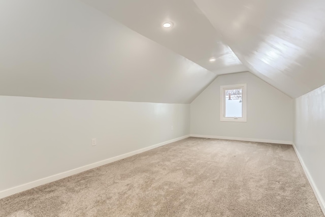 bonus room featuring light colored carpet and vaulted ceiling