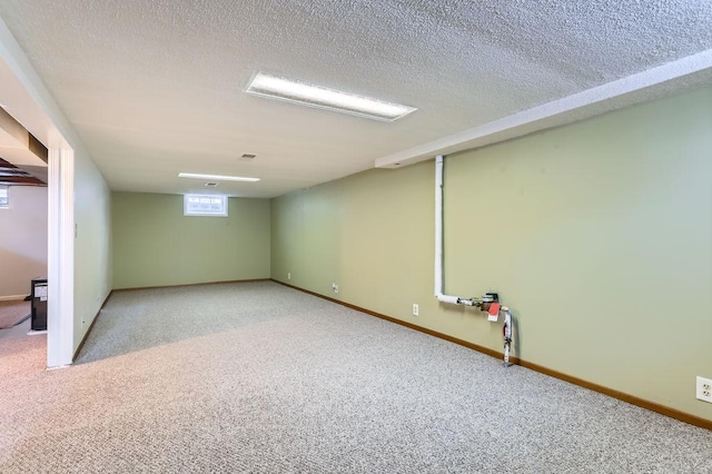 basement with light carpet and a textured ceiling