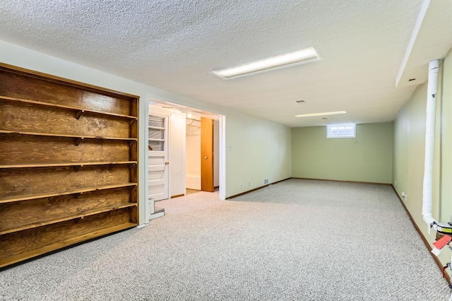 basement featuring light carpet and a textured ceiling