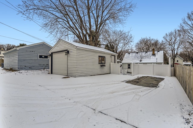 exterior space featuring a garage and an outbuilding