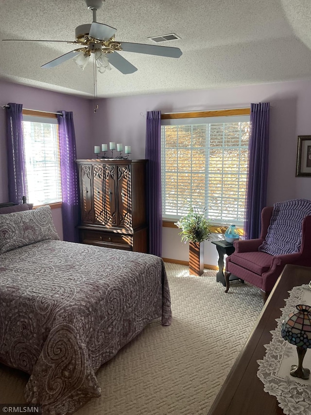 bedroom with a textured ceiling and ceiling fan