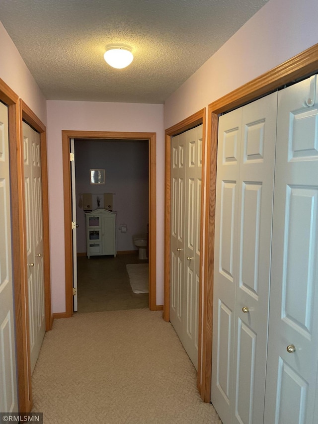 hallway featuring a textured ceiling