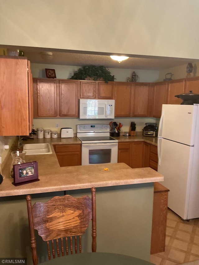 kitchen with sink and white appliances