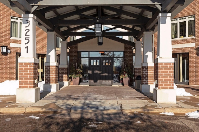 property entrance featuring brick siding