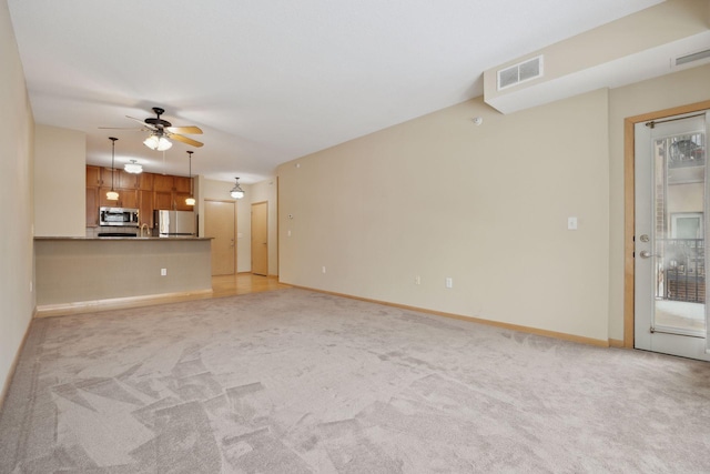 unfurnished living room with light carpet, baseboards, visible vents, and a ceiling fan