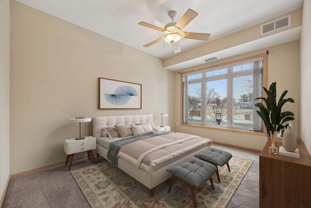 carpeted bedroom featuring ceiling fan, visible vents, and baseboards