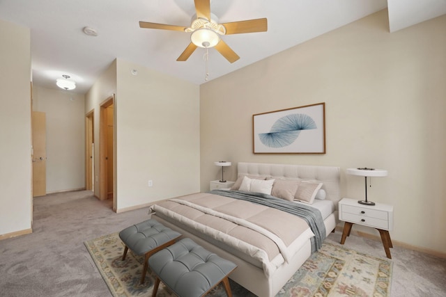 bedroom with light carpet, ceiling fan, and baseboards