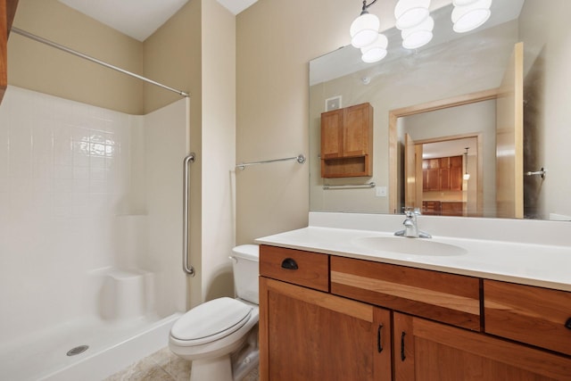 full bath with vanity, a shower stall, and toilet