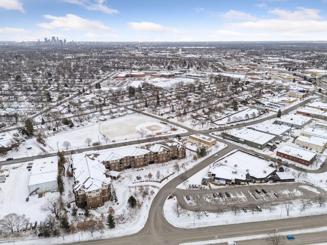 snowy aerial view with a city view