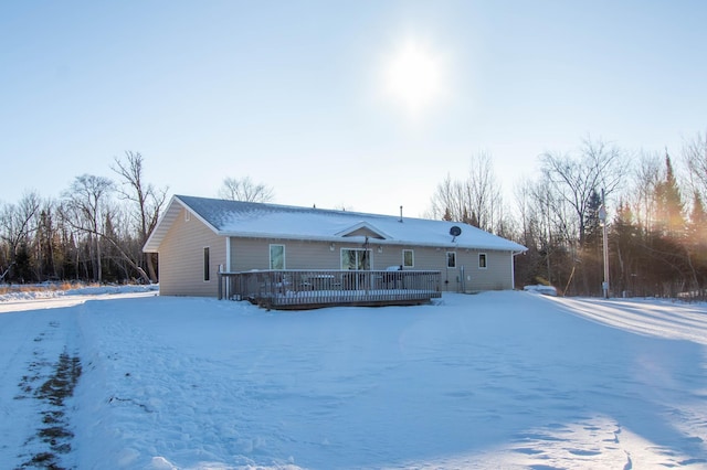 snow covered property with a deck