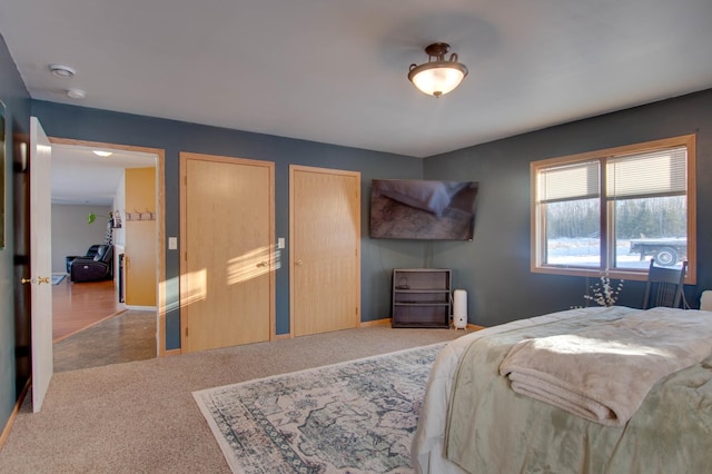 bedroom featuring carpet floors and two closets