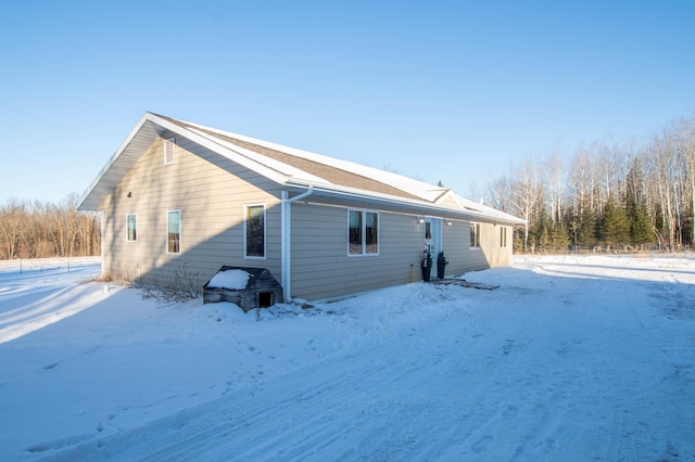 view of snow covered rear of property