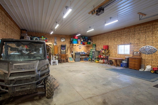 garage with a garage door opener and a workshop area