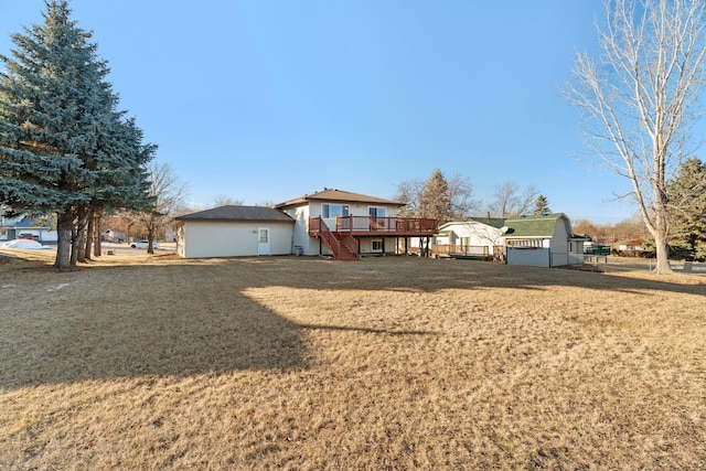 view of front of property with a deck and a front lawn