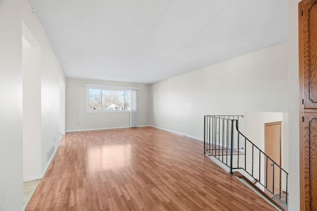 spare room with light hardwood / wood-style floors