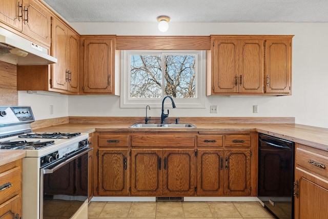 kitchen featuring black dishwasher, sink, a textured ceiling, and white gas range oven