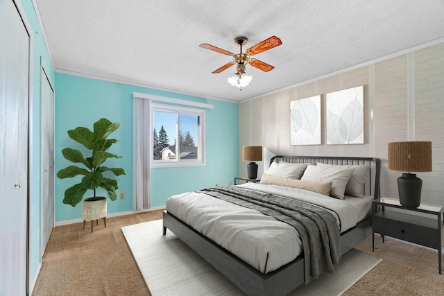 bedroom with ornamental molding, carpet floors, ceiling fan, and a textured ceiling