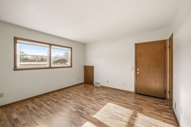 spare room with light hardwood / wood-style flooring