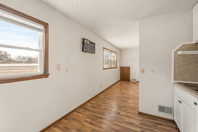 hall featuring dark hardwood / wood-style floors and a wall mounted air conditioner