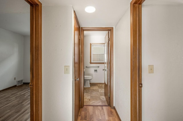 corridor with light hardwood / wood-style flooring