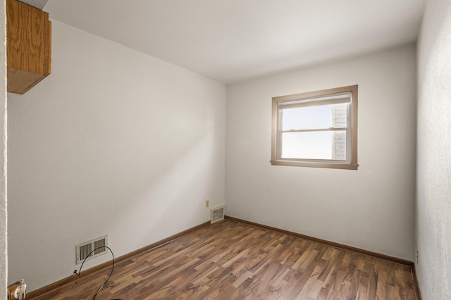 spare room with dark hardwood / wood-style floors