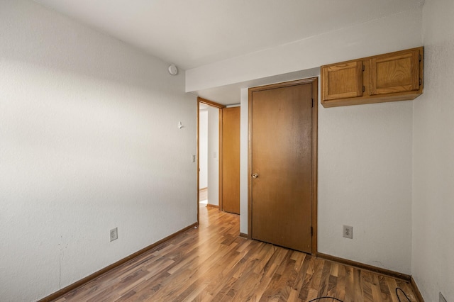 unfurnished bedroom with hardwood / wood-style floors