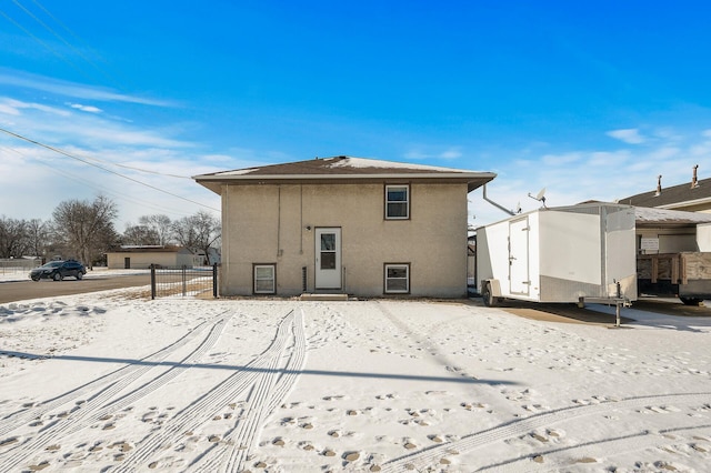 view of snow covered rear of property