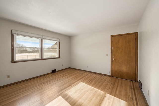 spare room with light hardwood / wood-style flooring