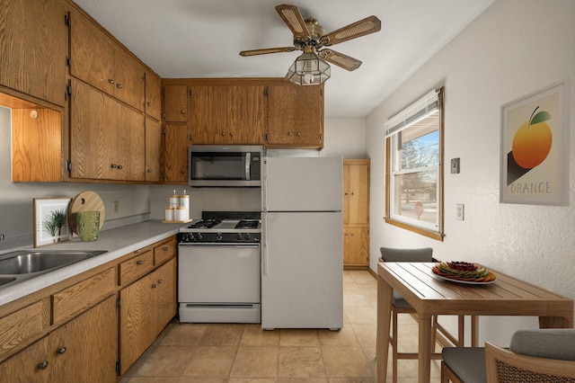 kitchen with ceiling fan, sink, and white appliances