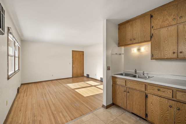 kitchen with sink and light hardwood / wood-style flooring