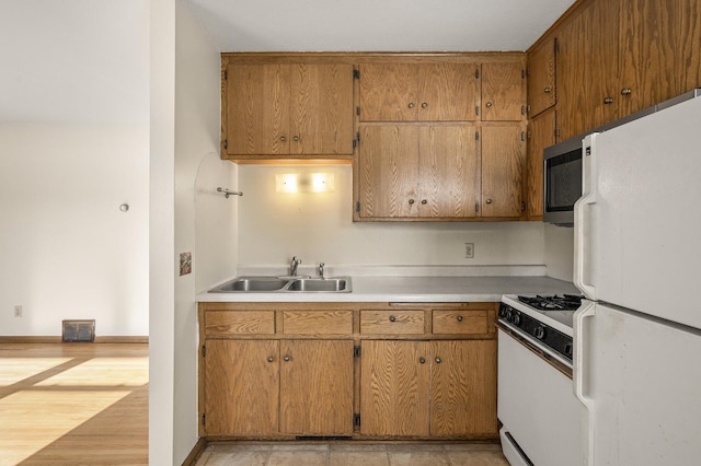 kitchen with sink and white appliances