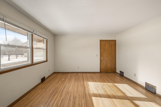 spare room with light hardwood / wood-style floors