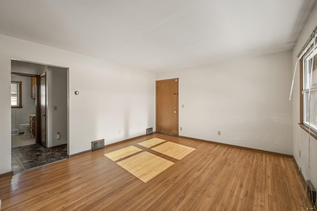 unfurnished room featuring hardwood / wood-style floors