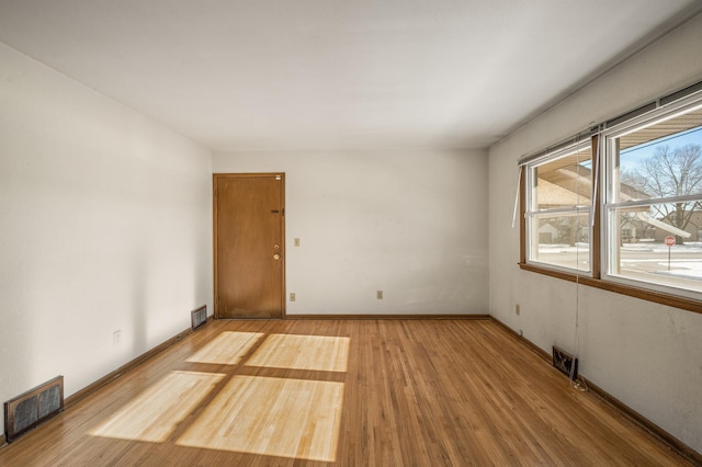 spare room featuring hardwood / wood-style floors