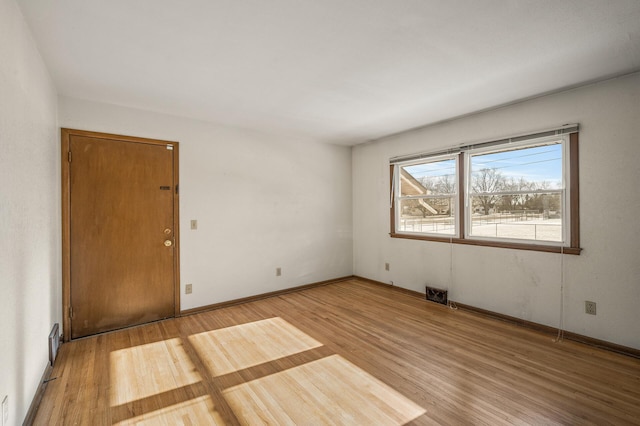 empty room with hardwood / wood-style flooring