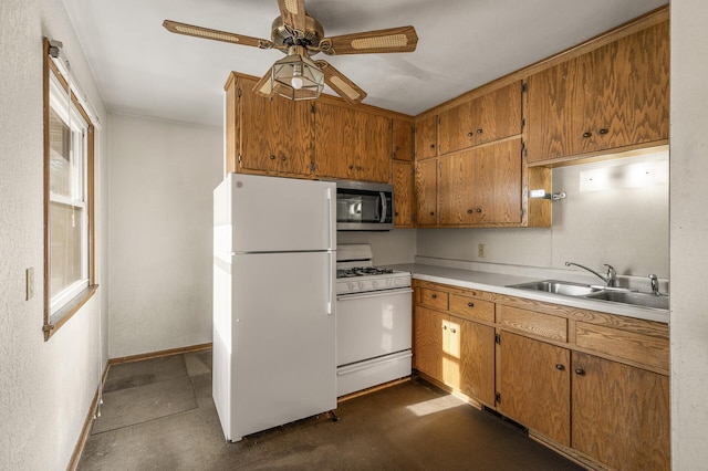 kitchen with ceiling fan, sink, and white appliances