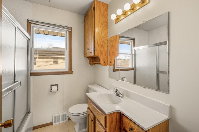 full bathroom featuring vanity, toilet, tile patterned flooring, and combined bath / shower with glass door