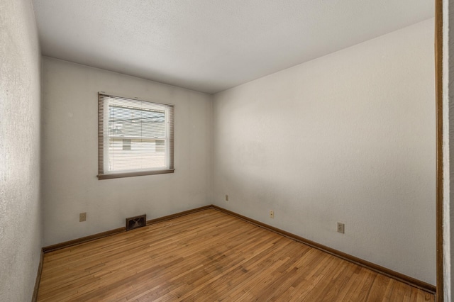 spare room with light hardwood / wood-style floors