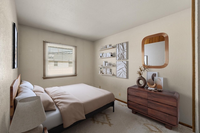 carpeted bedroom featuring a textured ceiling