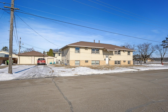 bi-level home with an outbuilding and a garage